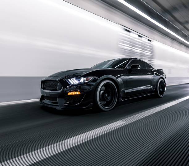Black Shelby GT 500 driving on the road